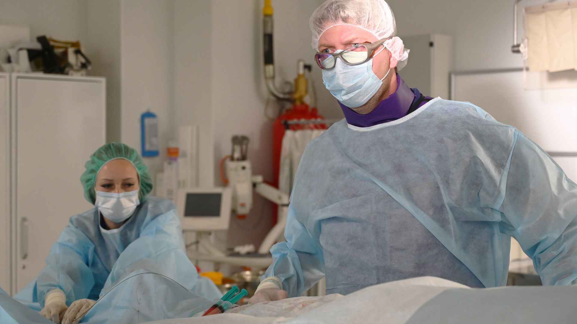Doctors performing endovascular surgery in modern operating room